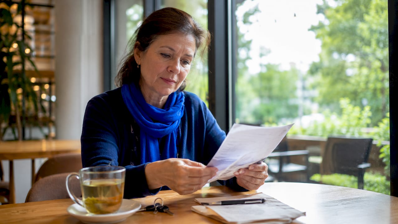 Caregiver reviewing hospital discharge papers at home