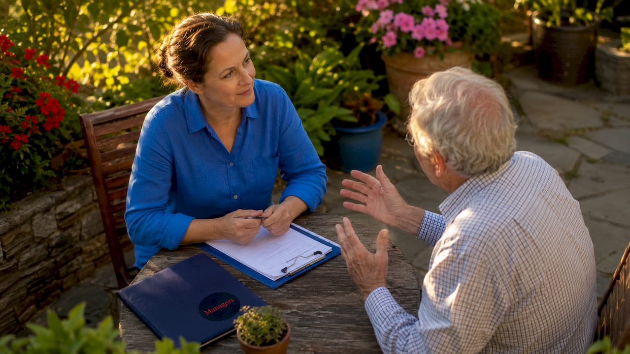 Family discussing home care plans at kitchen table