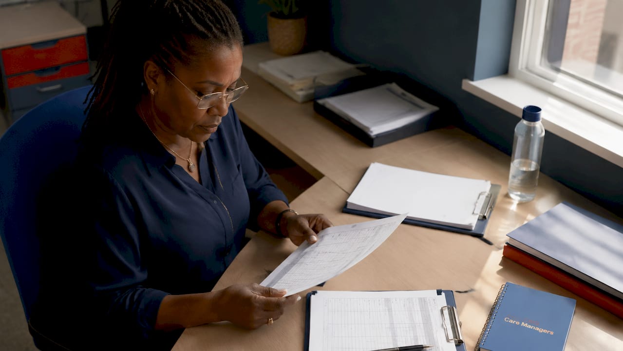 Healthcare manager reviewing contract care staffing documents